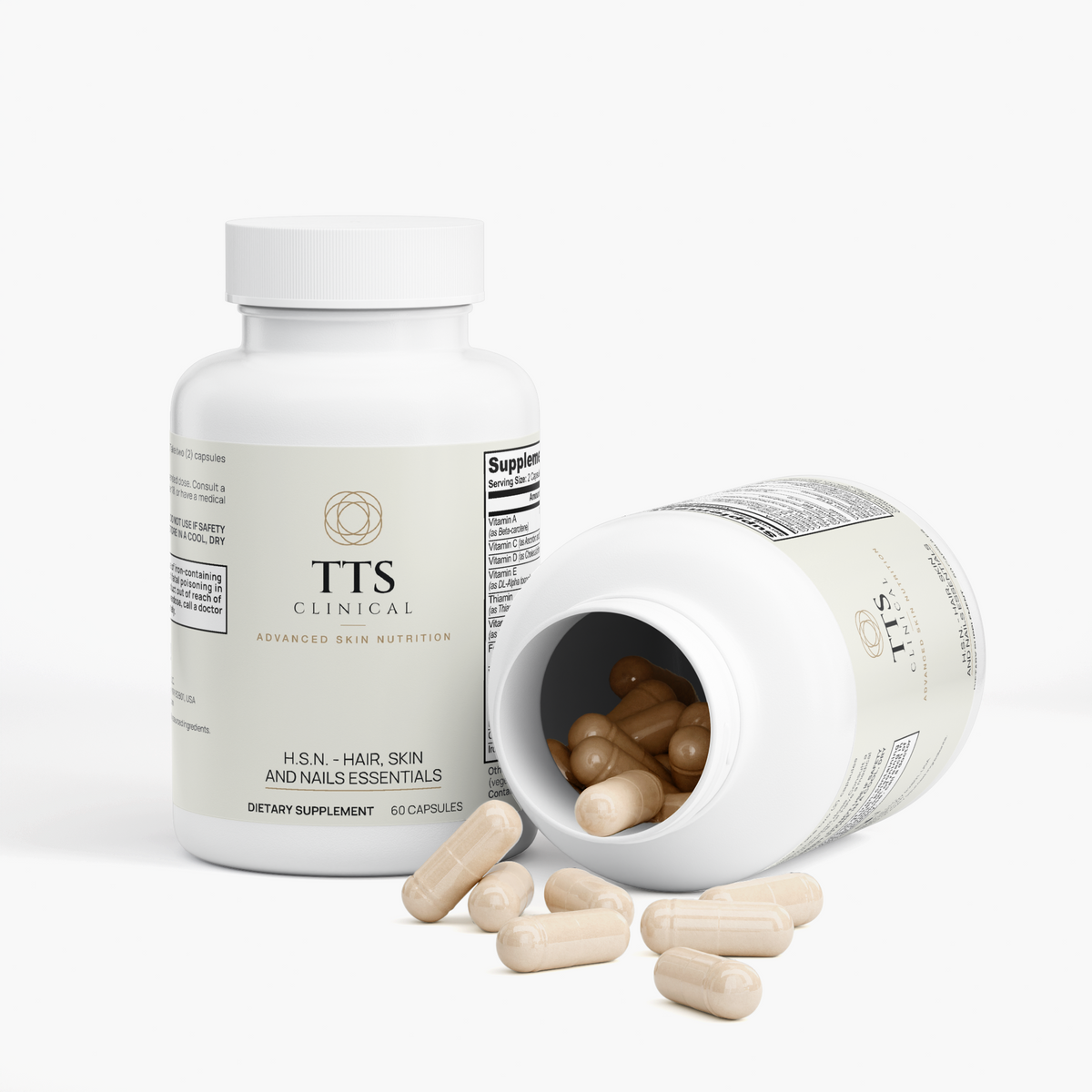 Two H.S.N. Hair, Skin and Nails bottles, one tipped open with capsules spilling out