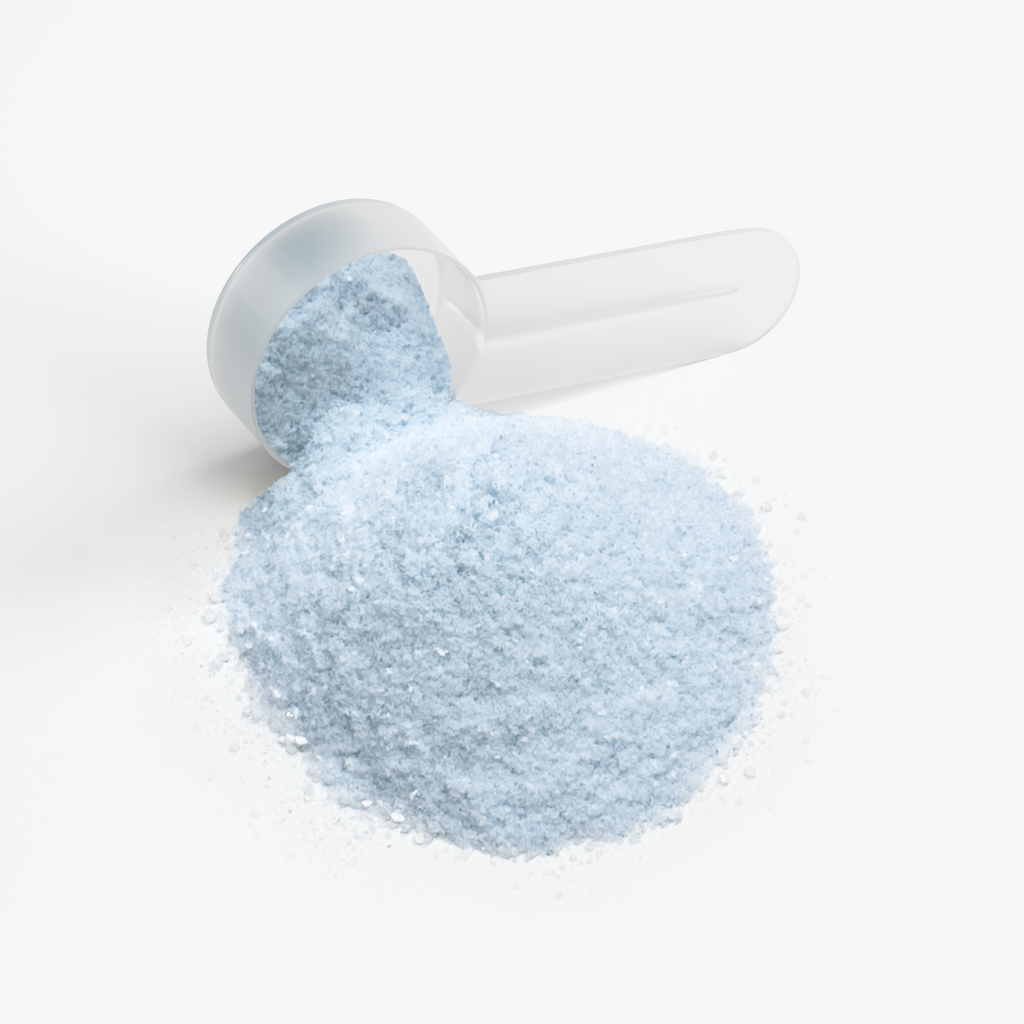 Scoop with a mound of pale blue DERMAJOLT Cotton Candy powder